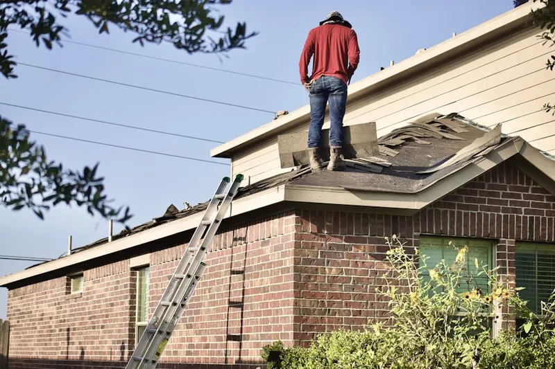 Professional roofer working on a residential roof in Harrisville